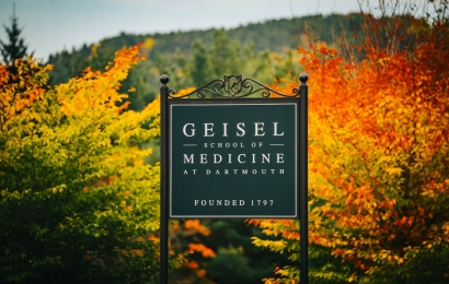 Geisel school of medicine sign with bright foliage in the background
